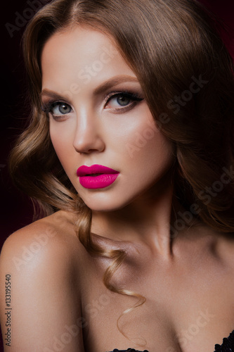Close-up portrait of beautiful woman with bright make-up and hairstyle.