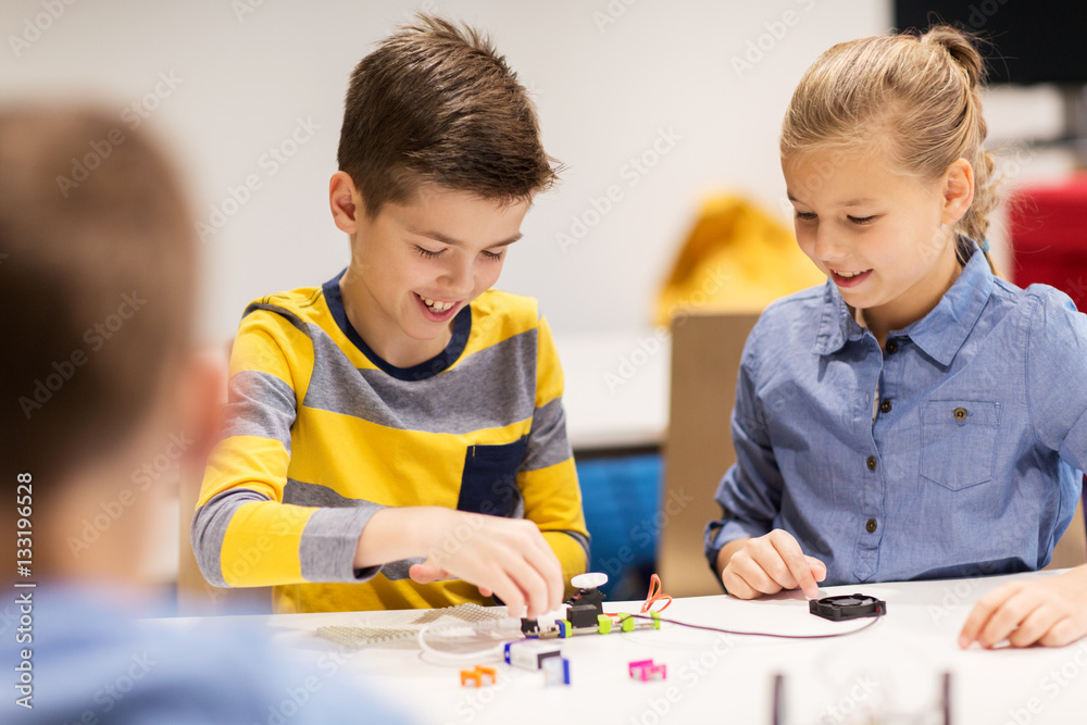 happy children building robots at robotics school happy children building robots at robotics school