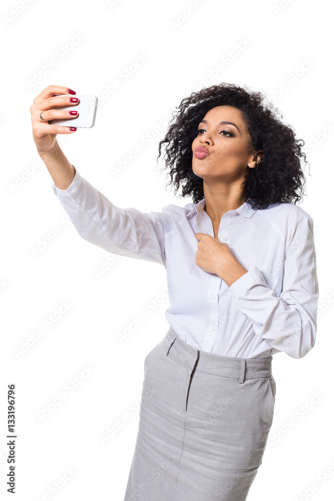 Beautiful brunette woman in classic white shirt and skirt make selfie on the phone. Beautiful brunette woman in classic white shirt and skirt make selfie on the phone.