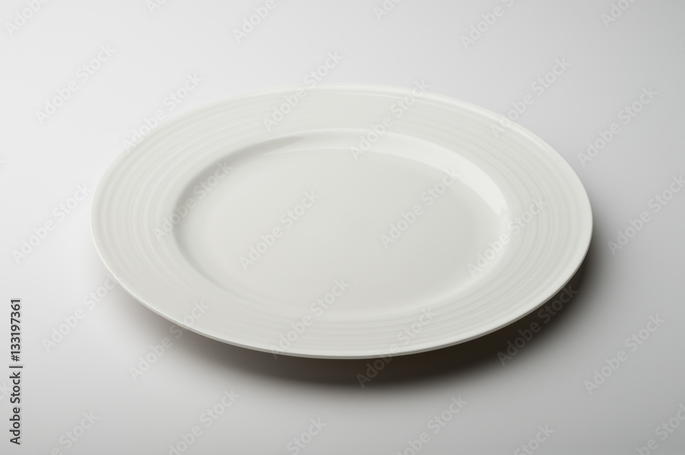 Empty round white plate with decorated border Empty round white plate with decorated border