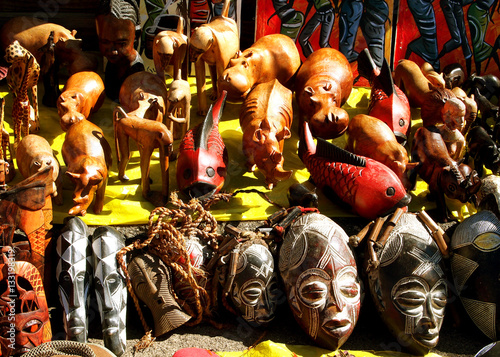 African wooden and stone souvenirs masks and wild animals. Local market. South Africa.