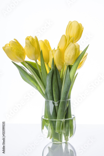 Fototapeta Naklejka Na Ścianę i Meble -  Yellow tulips flowers bouquet in a glass vase