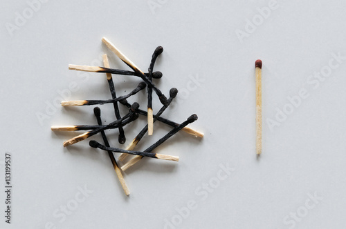 Pile of burnt matches and one unused.