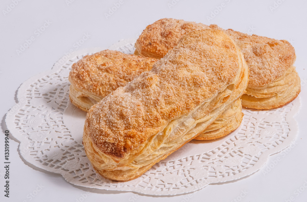 Baked puff pastry on a white background. Baked puff pastry on a white background.