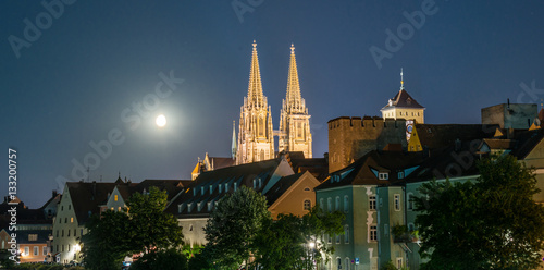 Nachtaufnahme von Regensburg mit Mond neben dem Dom