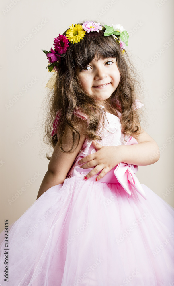 Small girl in pinky wedding dress isolated inside studio Small girl in pinky wedding dress isolated inside studio