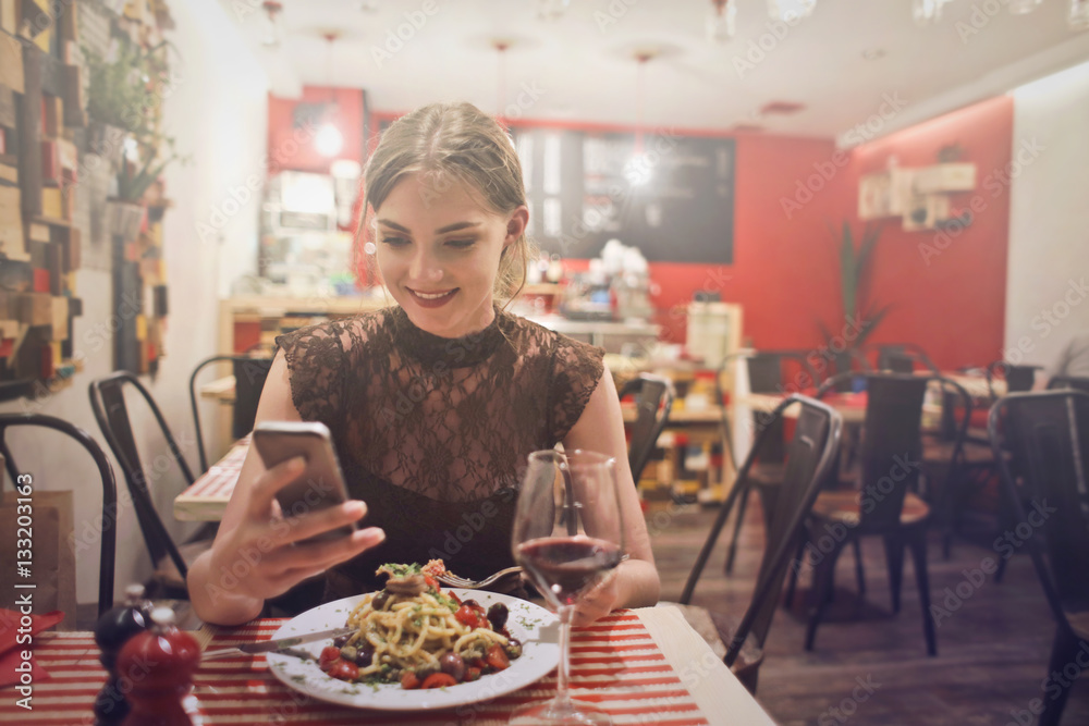 Girl playing on phone during dinner