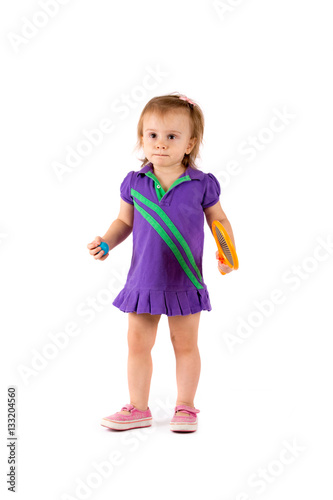 Little cute girl playing tennis on a white background