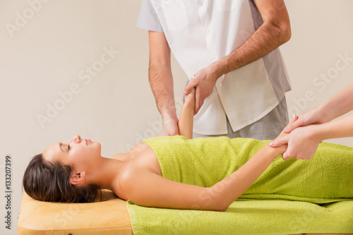 wellness massage in the spa salon make four hands photo