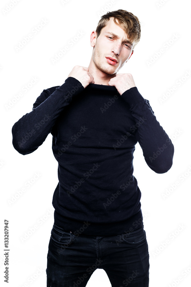 handsome young man in black jumper posing in studio handsome young man in black jumper posing in studio