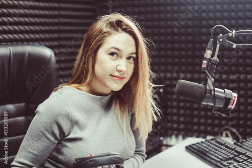 Fotografija the girl at the microphone in the Studio
