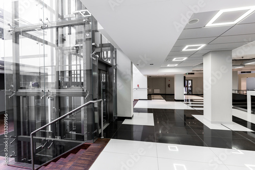 Modern hallway with glass elevator