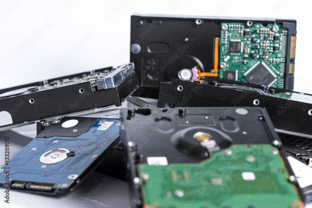 stack of old hard drives on white background stack of old hard drives on white background