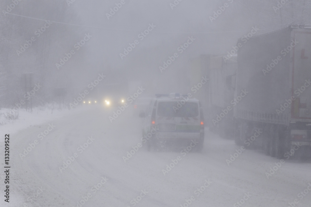 traffic jam of trucks in snowstorm. Snow calamity.