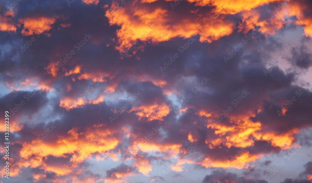 Blue sky background with white clouds. Sunset