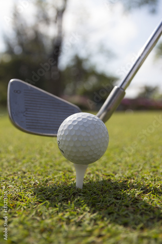 Golf balls and Driver on green grass background