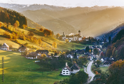 Obraz na płótnie Colourful countryside landscape with mountain forests, traditional houses and old monastery. Germany, Black Forest. w salonie