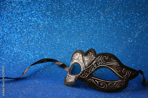 elegant venetian mask on blue glitter background