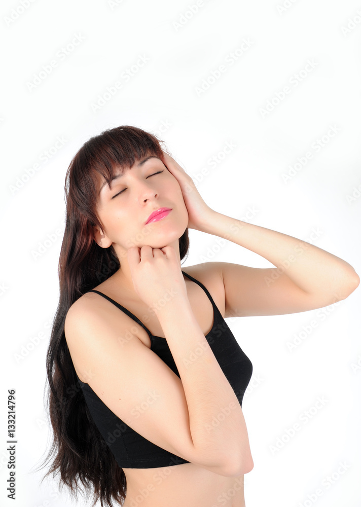 Young long-haired brunette woman in black lingerie on a white background with closed eyes touching face