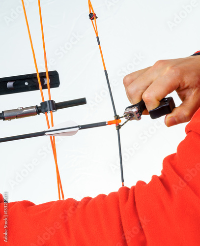 Hands of a person grabbing an archery release