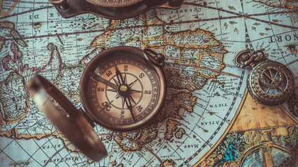  Antique bronze emblem compass on a retro world map vintage style.