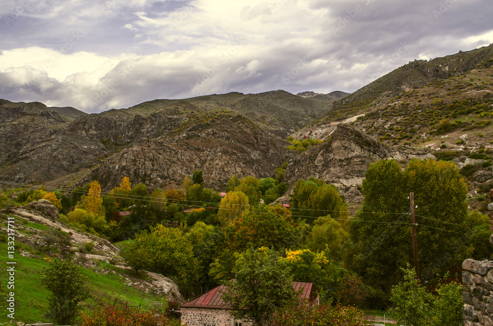 Mountain village in autumn day before the rain and the sky covered heavy,dark clouds
