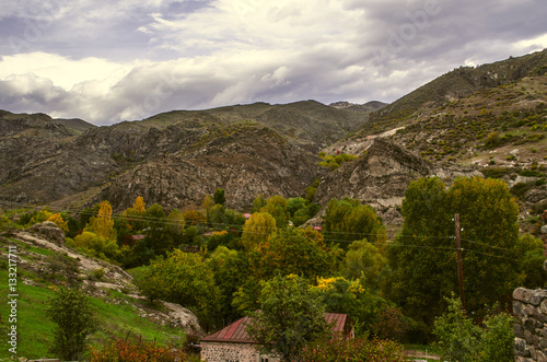 Mountain village in autumn day before the rain and the sky covered heavy,dark clouds 