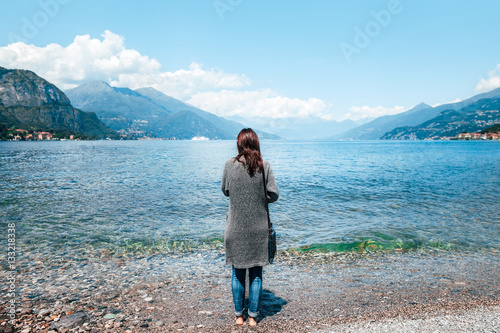 Back view of young lonely woman relaxing on Como Lake in Italy © GVS