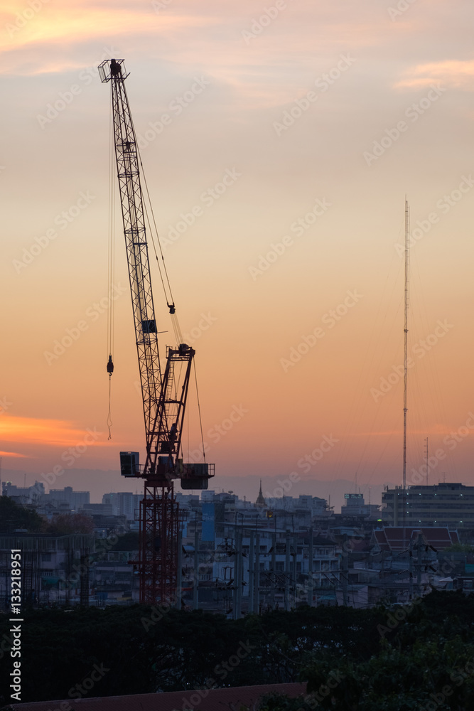 Construction crane at sunset time