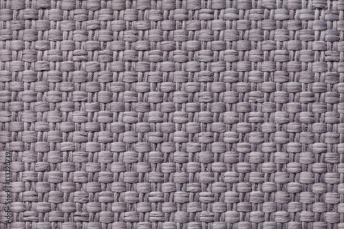 Light gray textile background with checkered pattern, closeup. Structure of the fabric macro.