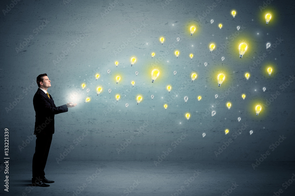 Businessman holding lightbulbs Businessman holding lightbulbs