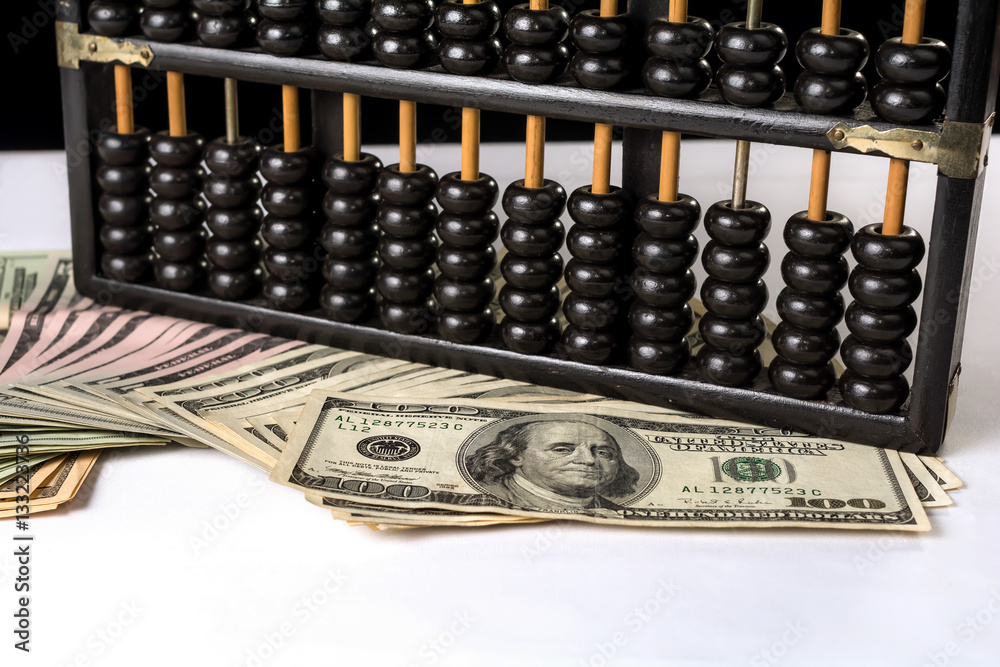 Currency war.
Wooden abacus beads and US dollar banknote,isolated white tablecloth background.
Currency war.
Wooden abacus beads and US dollar banknote,isolated white tablecloth background.