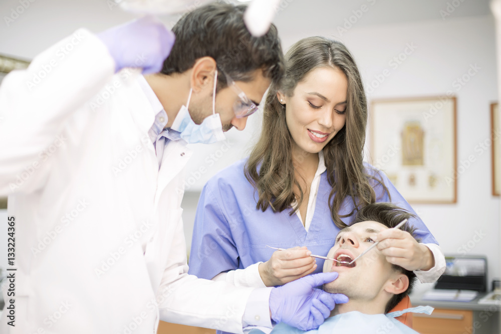 Fototapeta premium Young man having dental chekup at dentist office