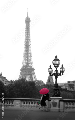 Couple kissing in front of the Eiffel Tower.