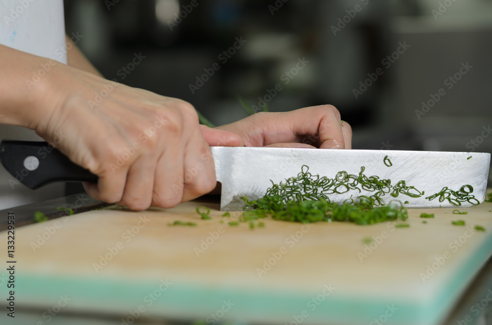 Chef training cut vegetable on cutting board with knife japan