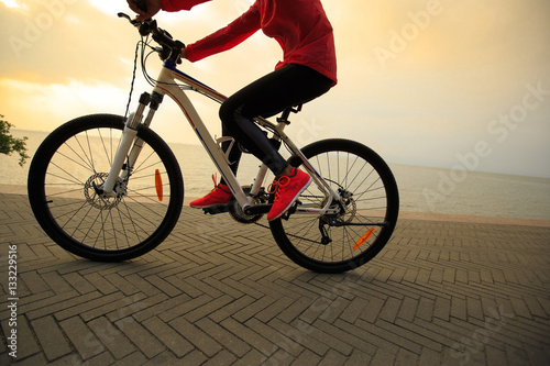 Fototapeta Naklejka Na Ścianę i Meble -  one young woman riding bike on seaside