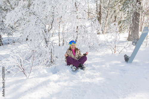 Portrait of young smiling woman meditating on snow
