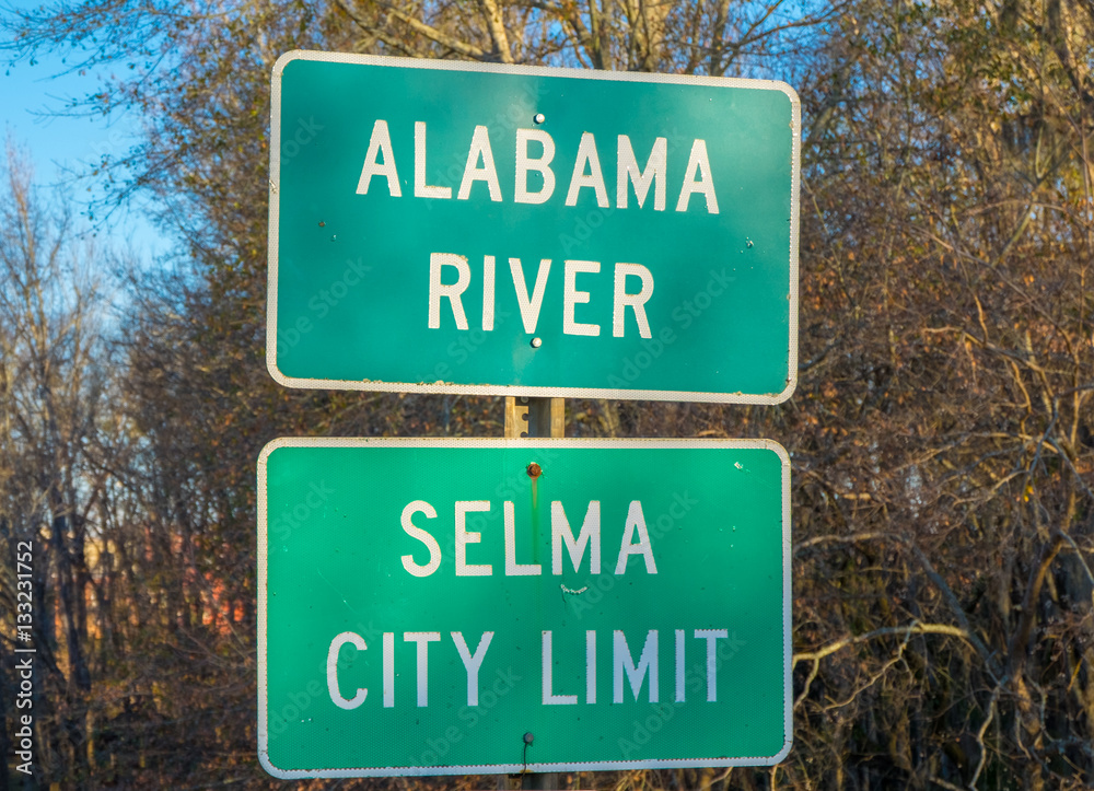 Green highway sign at the Edmund Pettus Bridge for Selma, Alabama Green highway sign at the Edmund Pettus Bridge for Selma, Alabama