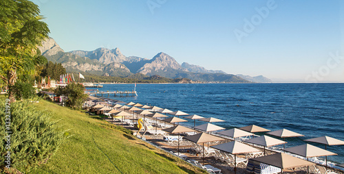 Sunshades and chaise lounges on beach. Turkey, Kemer. photo