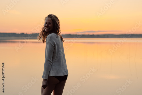 Young woman laughing at the beach