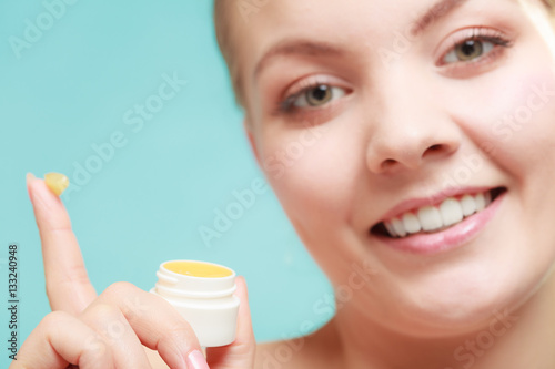 woman applying balsam for lips