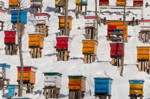 Beehives in the winter, covered with deep snow. Colorful background texture