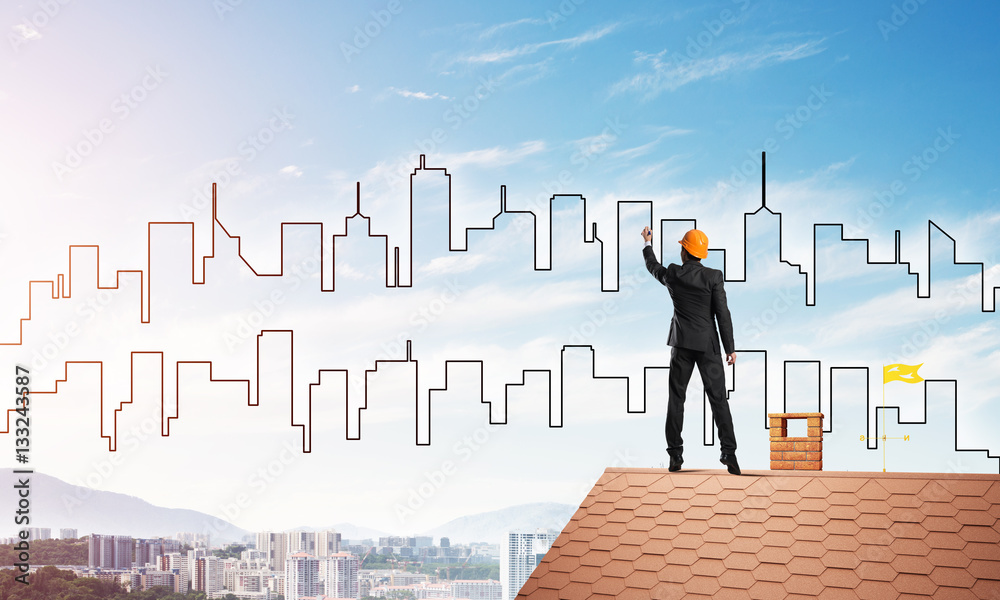 Man architect draw silhouette of modern city on blue sky. Mixed media Man architect draw silhouette of modern city on blue sky. Mixed media