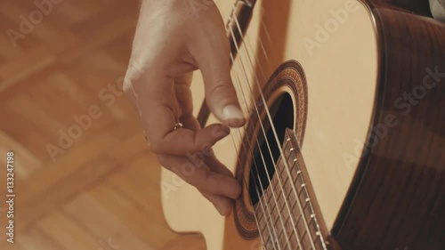 Hands of guitarist playing a guitar