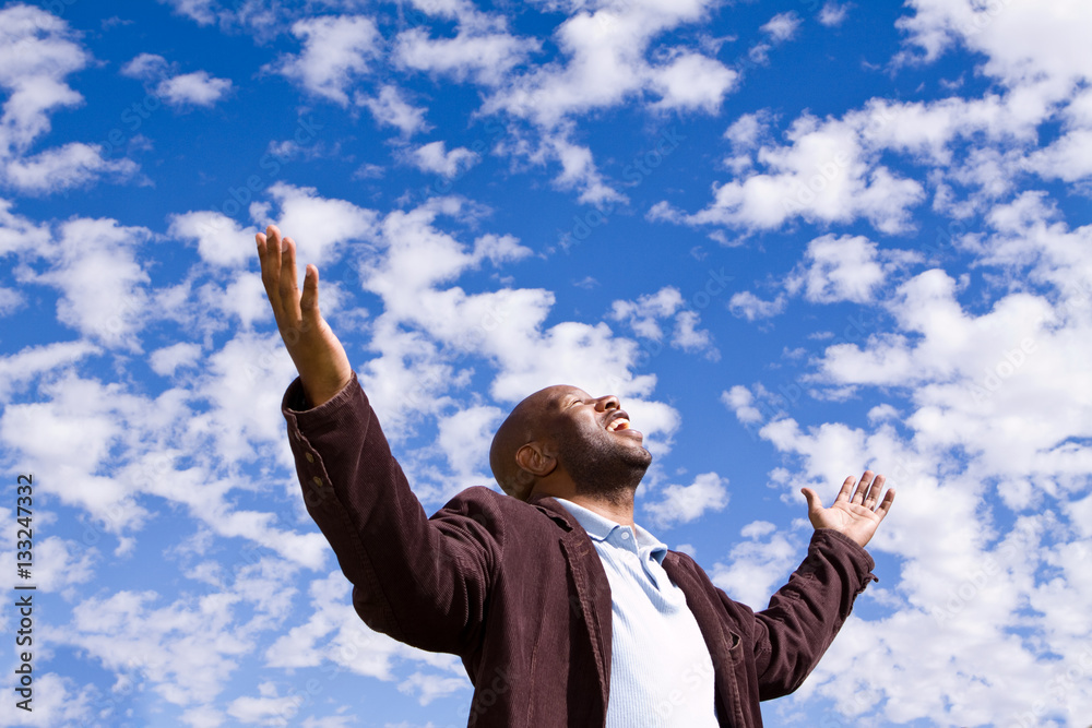 African American man stading outside with open arms. African American man stading outside with open arms.