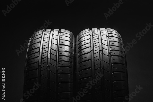 Studio shot of a set of summer, fuel efficient car tires on black background. Contrasty lighting and shallow depth of field