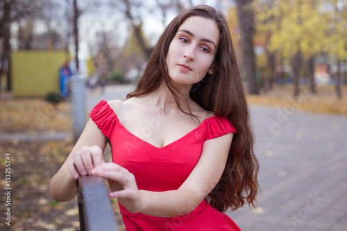 Fashionable stylish beautiful  girl with long hair walks in the city © 445017