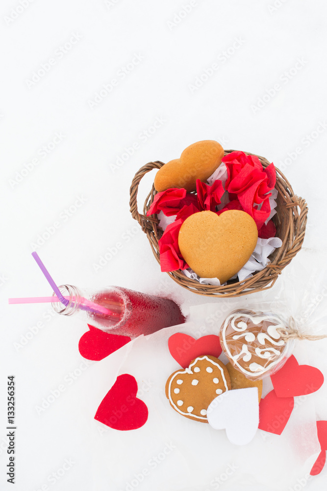 Gingerbread and cranberry lemonade with paper hearts on the snow Gingerbread and cranberry lemonade with paper hearts on the snow