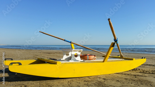 Yellow rescue boat on Italian beach. Adriatic sea. Emilia Romagna. Italy