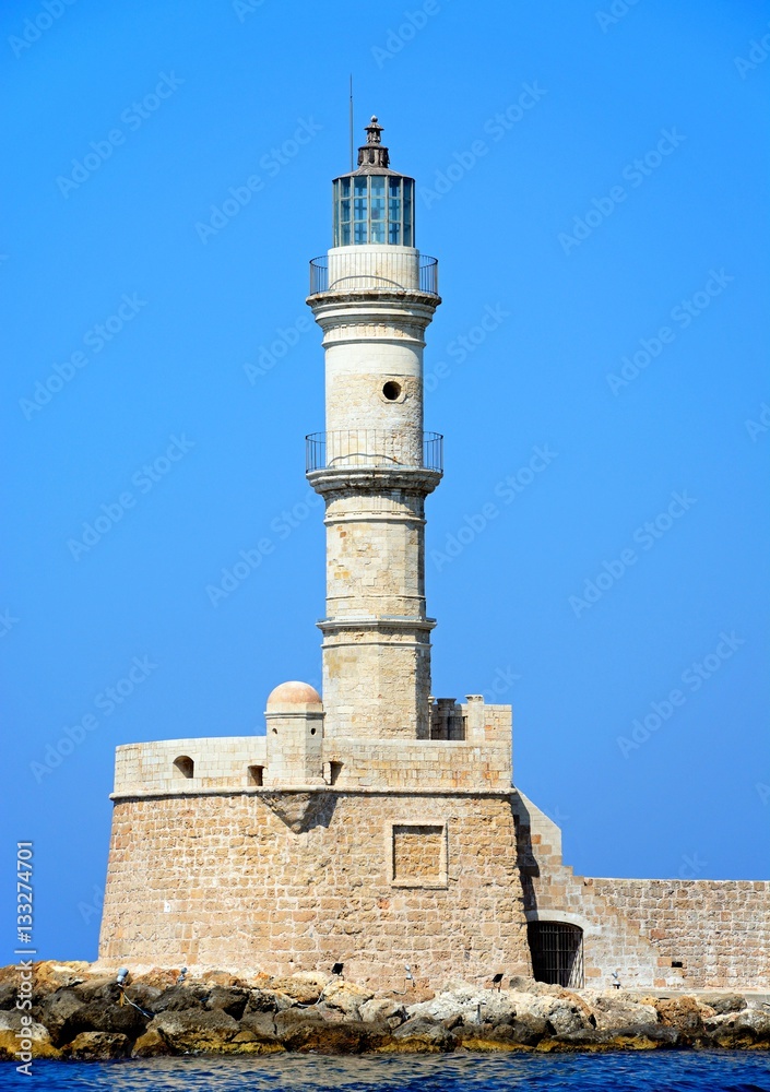 View of the Venetian lighthouse at the harbour entrance, Chania, Crete.